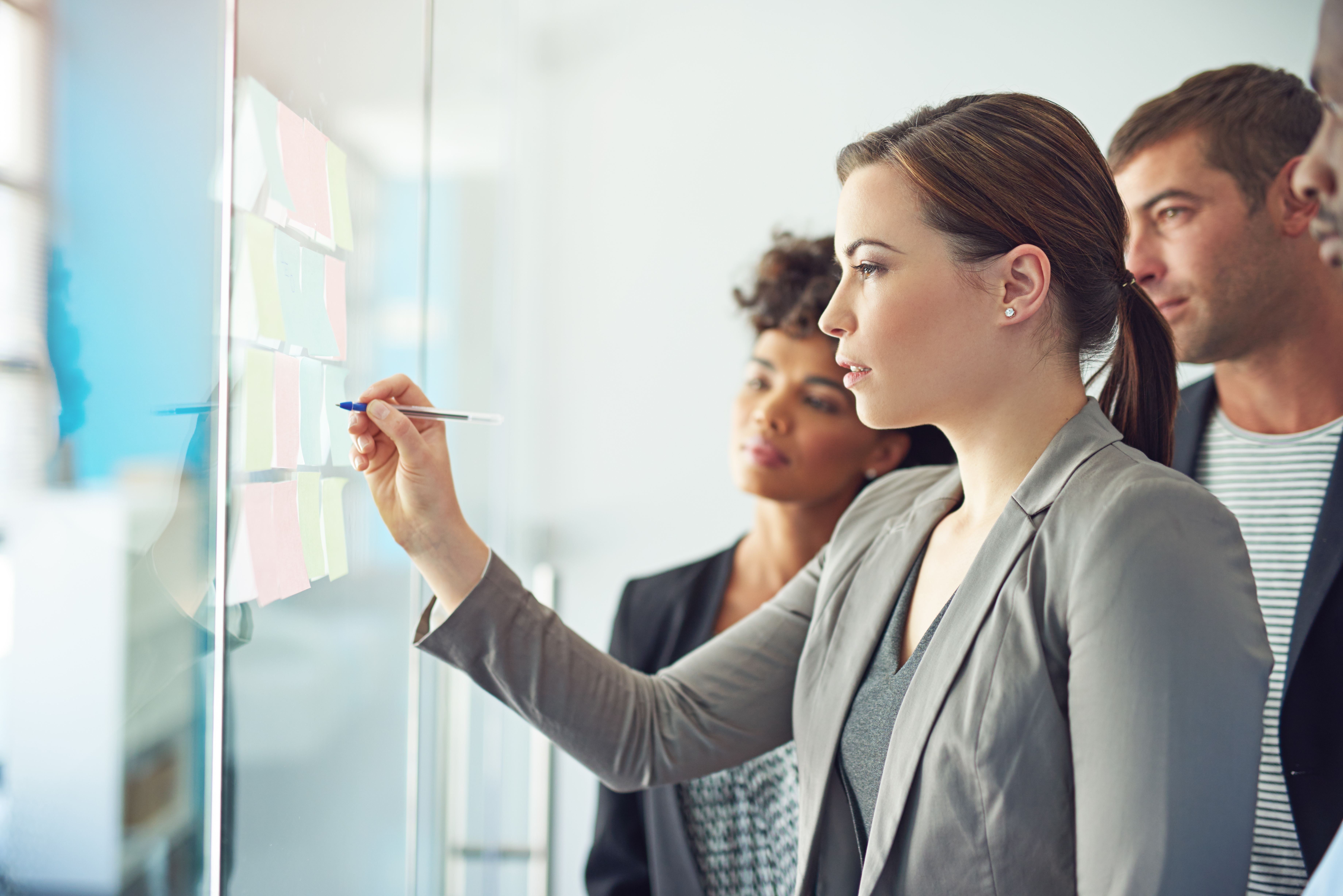 Two professional women working at a whiteboard