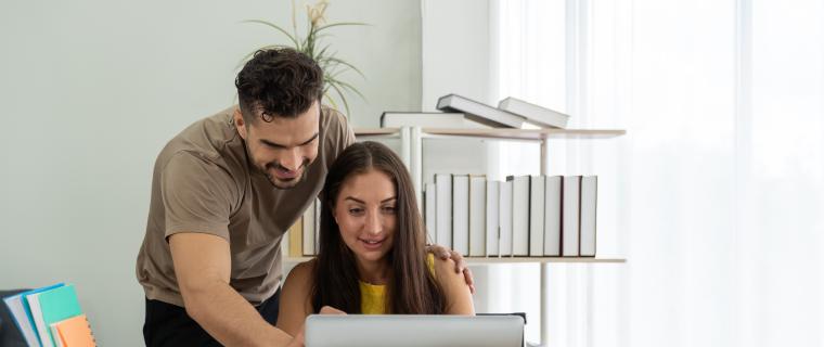 Photo of adults using computer together