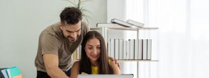 Photo of adults using computer together