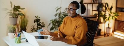 woman working at a desk with headphones on