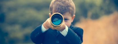 Young child looking through telescope