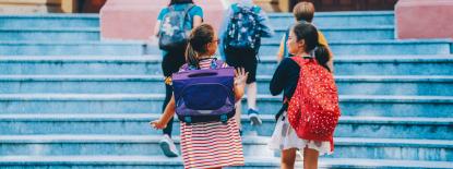 Photo of kids entering school building